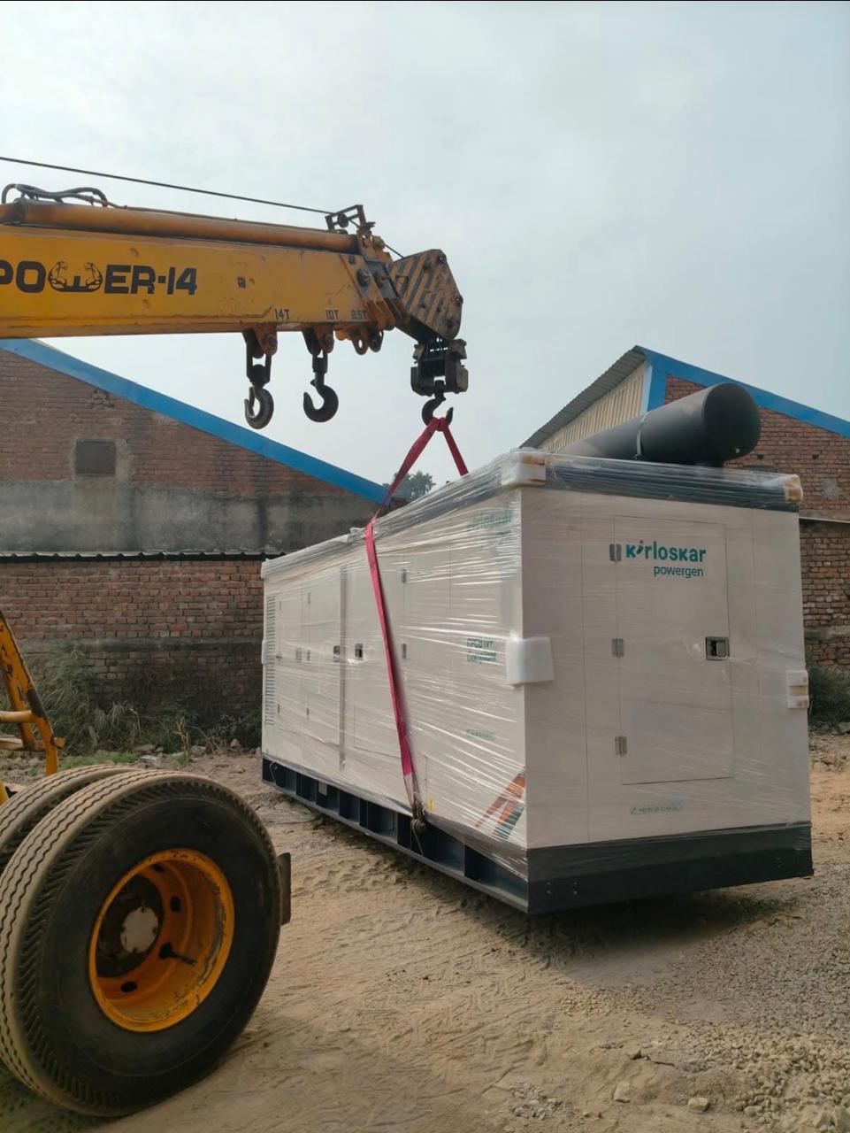 Heavy generator being craned onto a rural site for installation